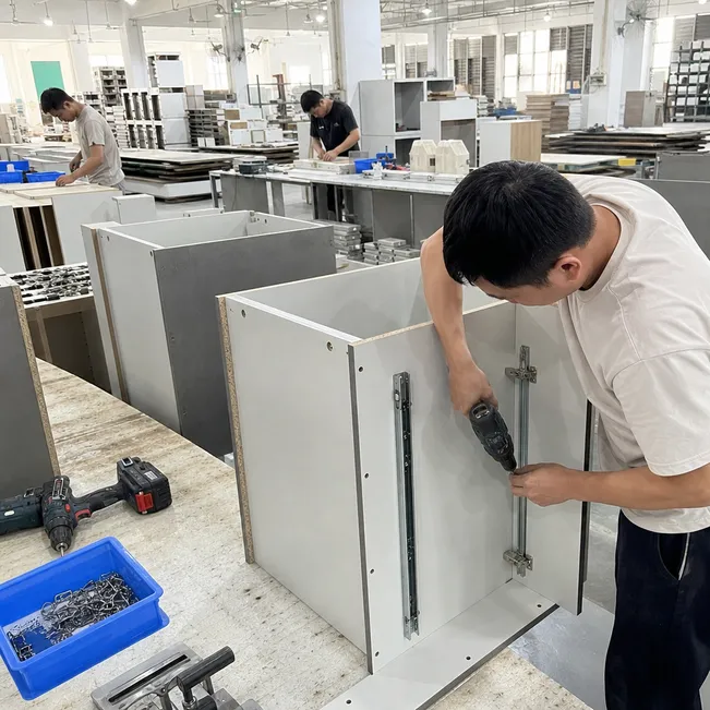 Kitchen cabinet production showing blockboard substrate with hinge and drawer slide hardware installation