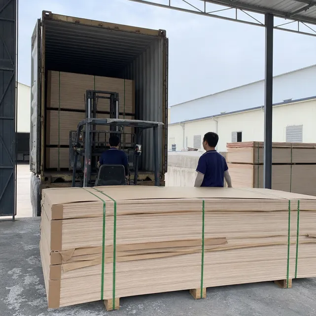 Blockboard panels bundled and loaded into export container with kraft paper interleaving and corner board protection