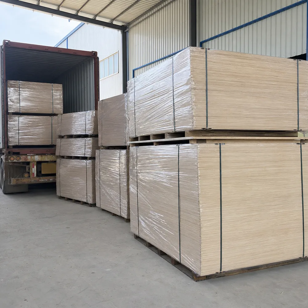 Commercial plywood bundles with steel banding and polyethylene film wrap ready for container loading
