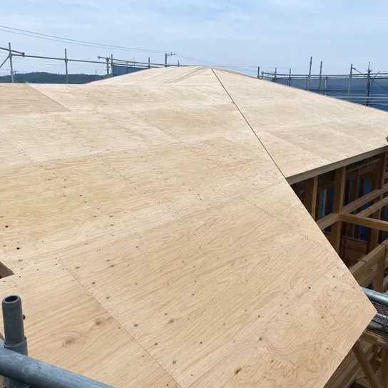 Exterior plywood roof sheathing installed on timber frame structure