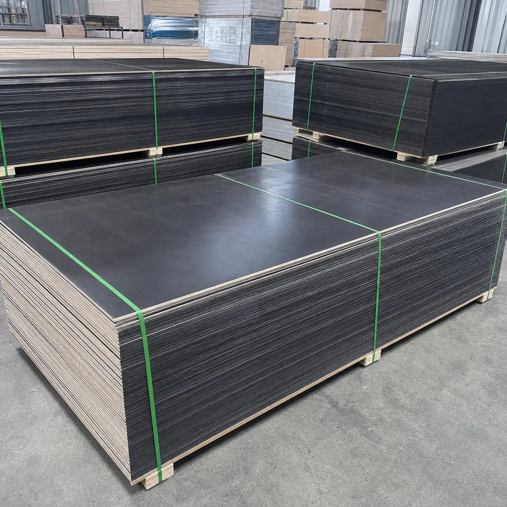 Stacked birch film faced plywood panels in warehouse showing black phenolic film surface and sealed edges
