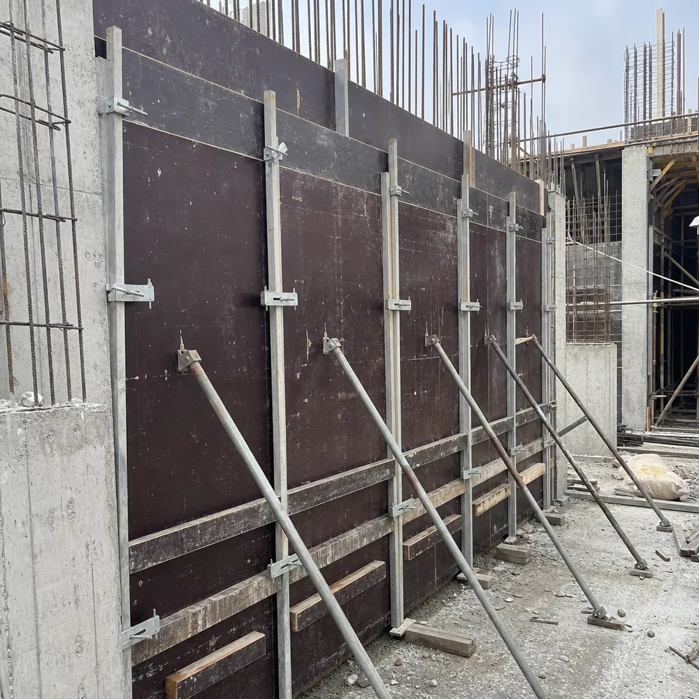 Birch film faced plywood panels used as concrete wall formwork on construction site