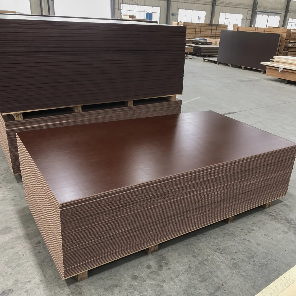 Brown film faced plywood panels stacked at QDPlywood factory — phenolic resin surface, sealed edges