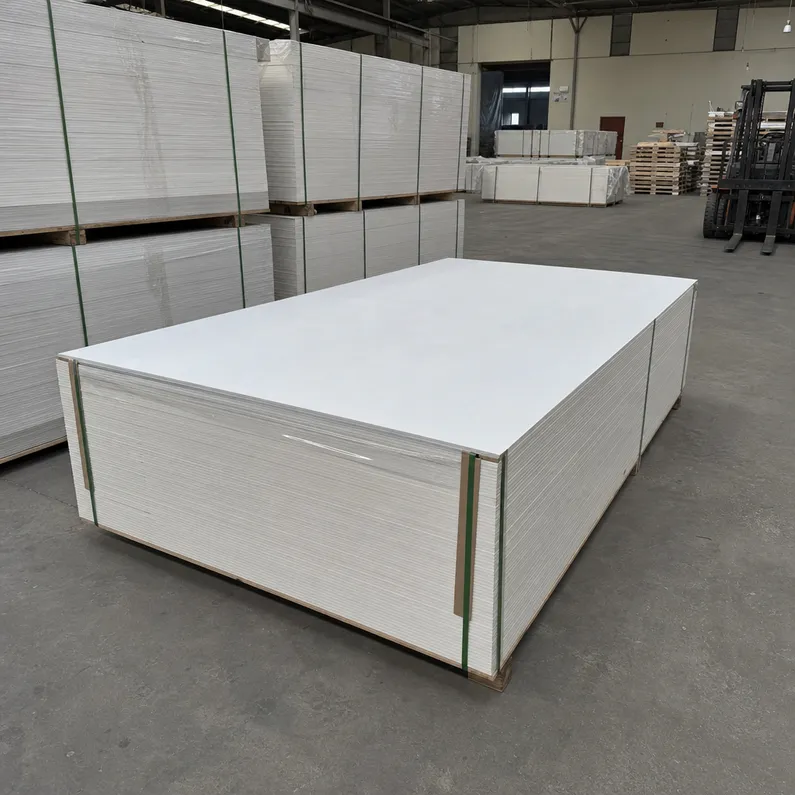 Factory-primed hardboard panels stacked and ready for dispatch — white primer surface, consistent finish