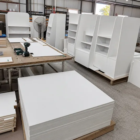 Primed hardboard used in retail display stands and point-of-sale fixture construction