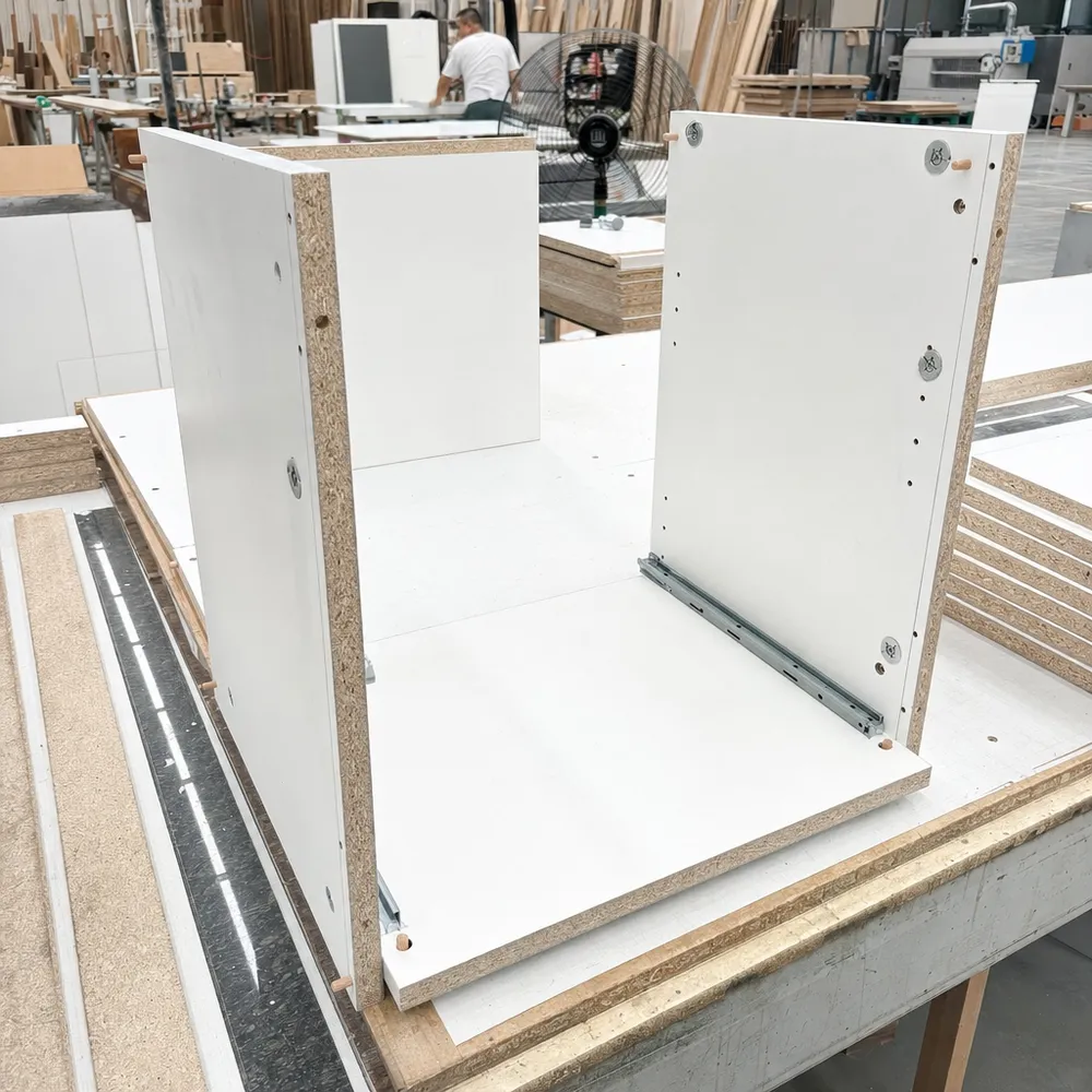 18mm melamine plywood panels used in kitchen cabinet carcass construction, showing cam lock and dowel joinery