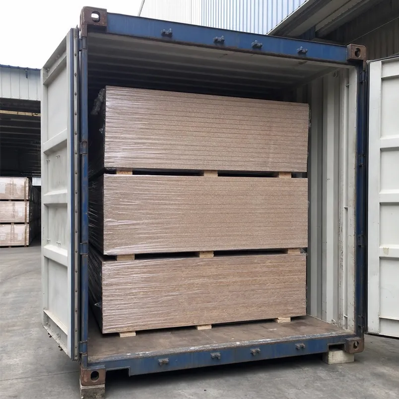 OSB and chipboard panels loaded in 40HQ container for export — stacked flat on timber bearers with moisture-resistant film wrapping