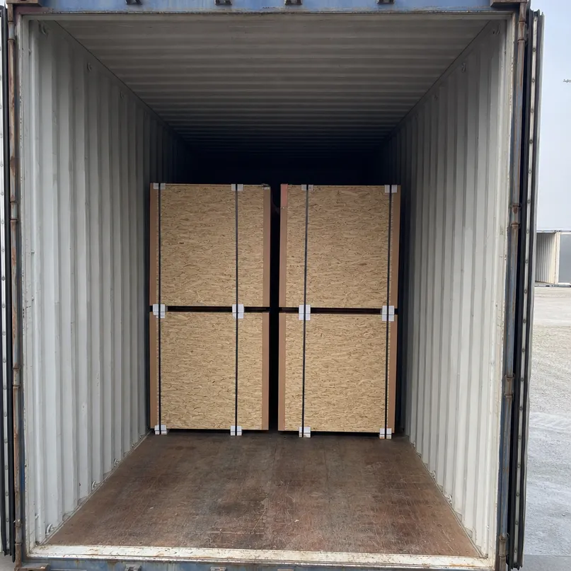 OSB flooring panels loaded in 40HQ container for export, showing bundle strapping and corner board protection